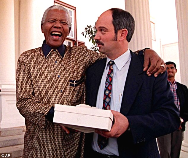 Friends for life: Nelson Mandela bursts out laughing with Christo Brand, his former guard from Pollsmoor Prison who had dropped by his home for his birthday in 1998.