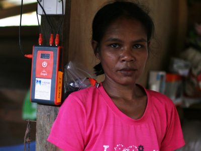 An orang asli beside her solar energy