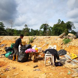 A woman sorting recyclables into categories.