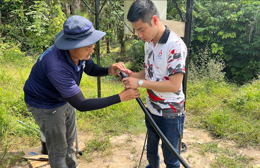 Mitsubishi volunteer supporting the installation of pipes for the solar water pump (SWP) at Bukit Serok Lama village